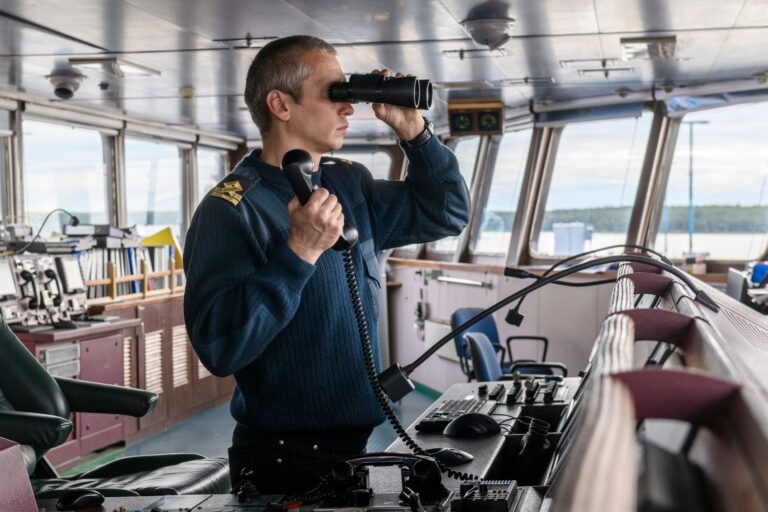 Deck,Officer,With,Binoculars,On,Navigational,Bridge.,Seaman,On,Board